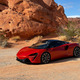 Front quarter view of a 2023 McLaren Artura in Burnt Orange.